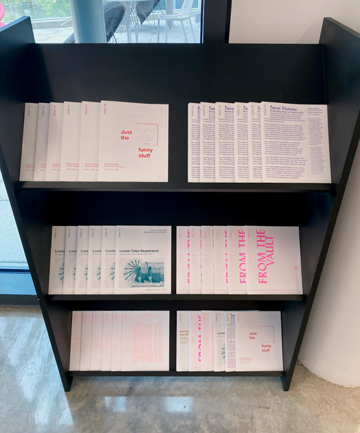 selection of printed takeaways on a bookshelf
