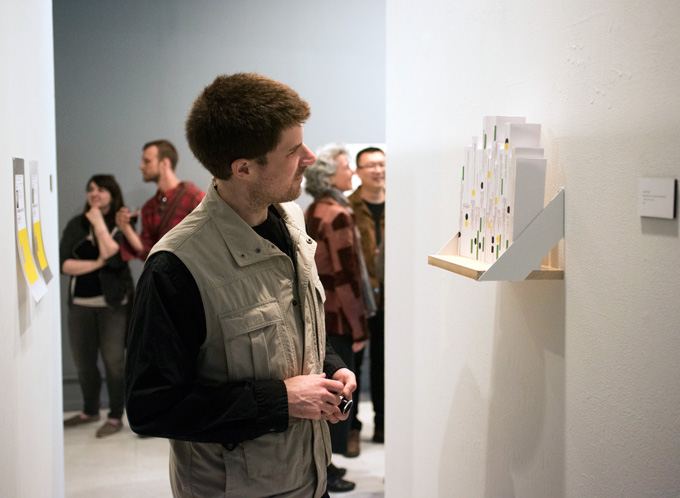 photo of person looking at book shelf